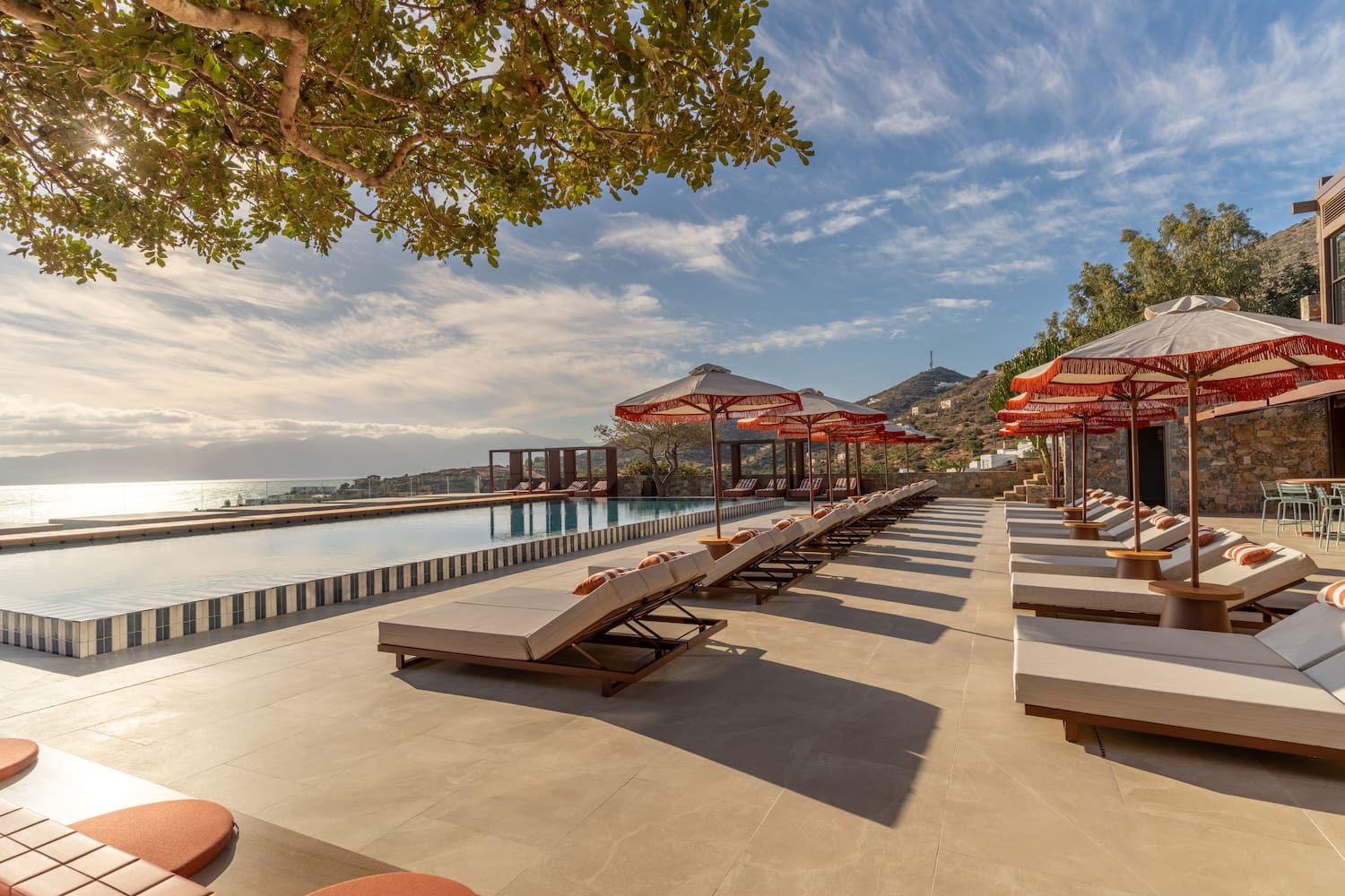 a pool with lounge chairs and umbrellas