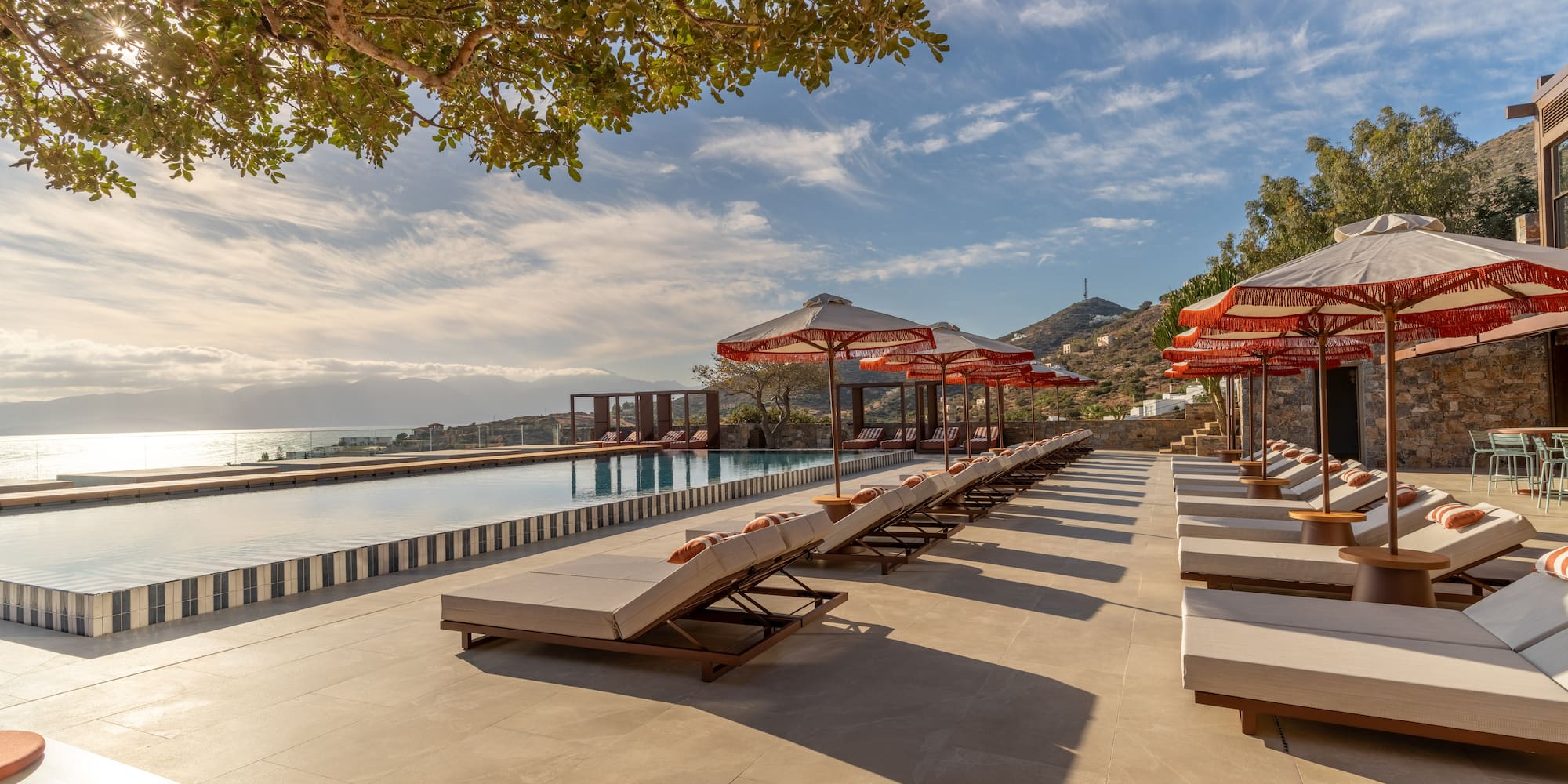 a pool with lounge chairs and umbrellas