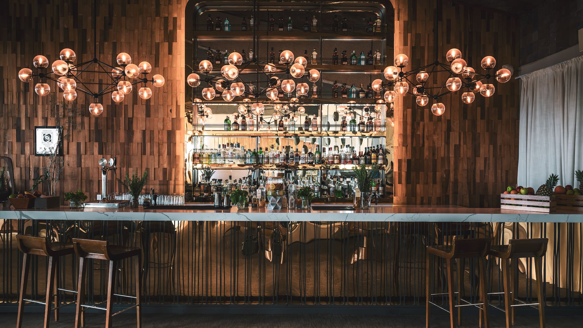 a bar with a chandelier and a bar