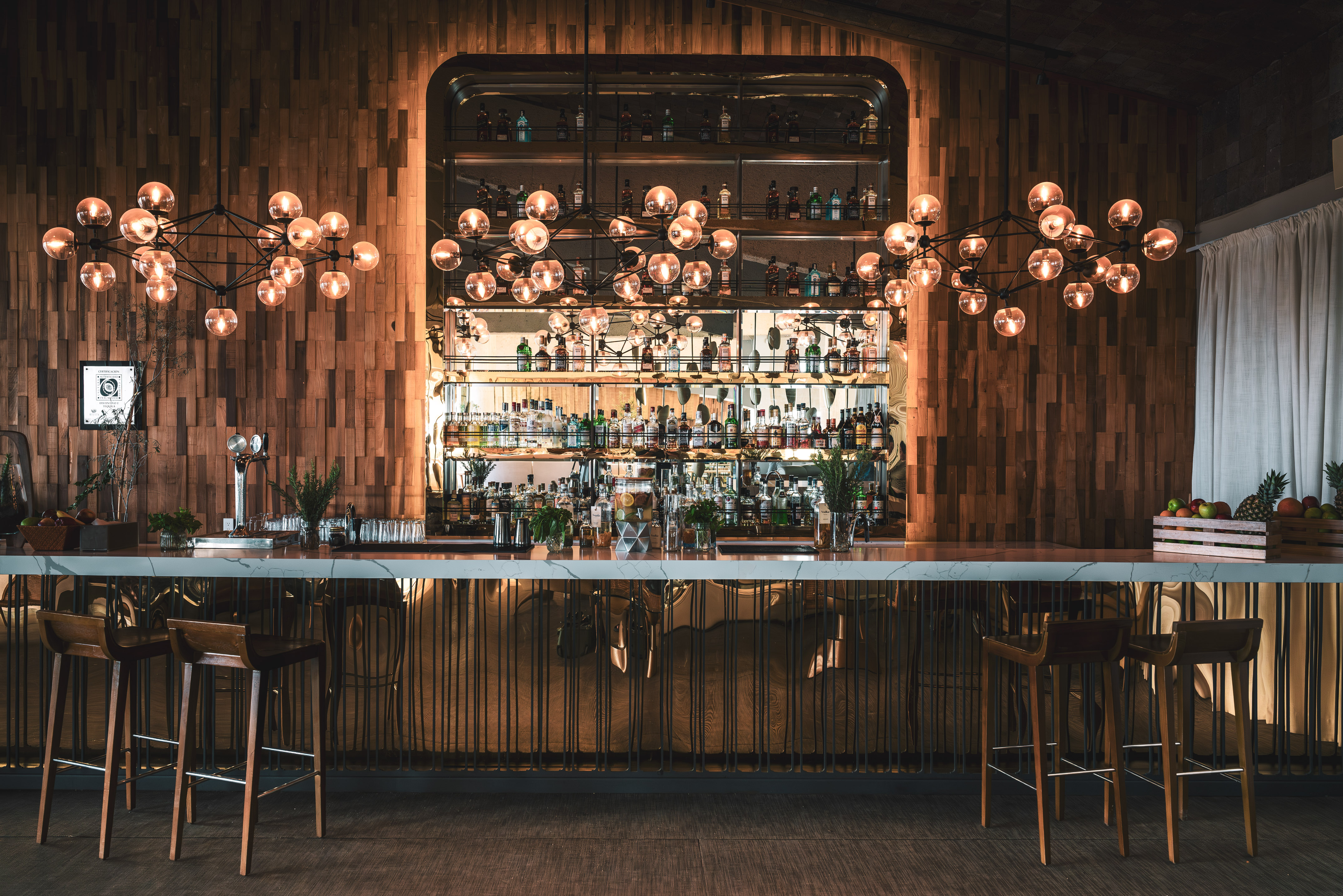 a bar with a chandelier and a bar