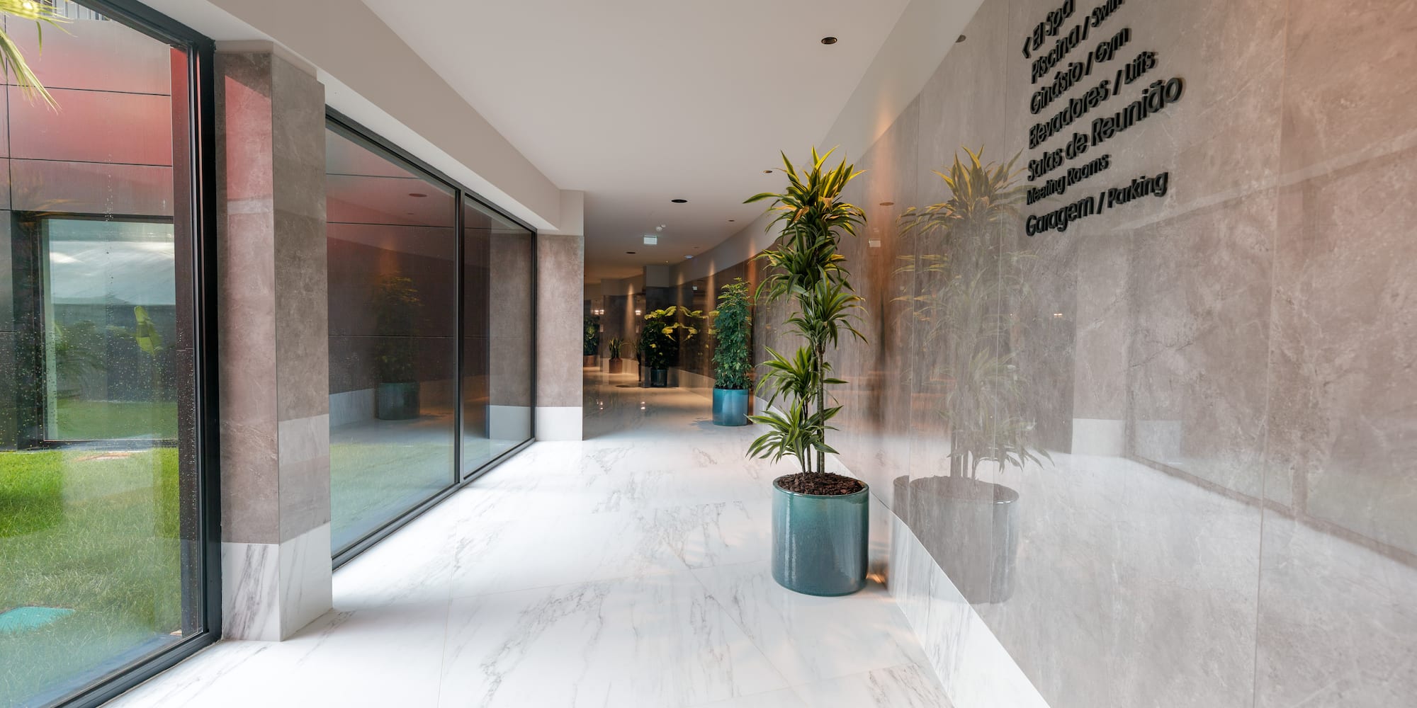 a building with a glass wall and a planter