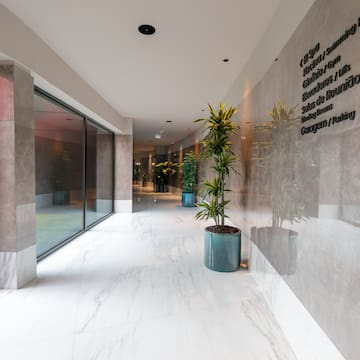 a building with a glass wall and a planter
