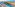 Resort infinity pool with sun loungers, palm trees, arid coast, and ocean.