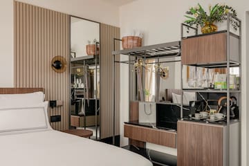 a room with a bed and a mirror