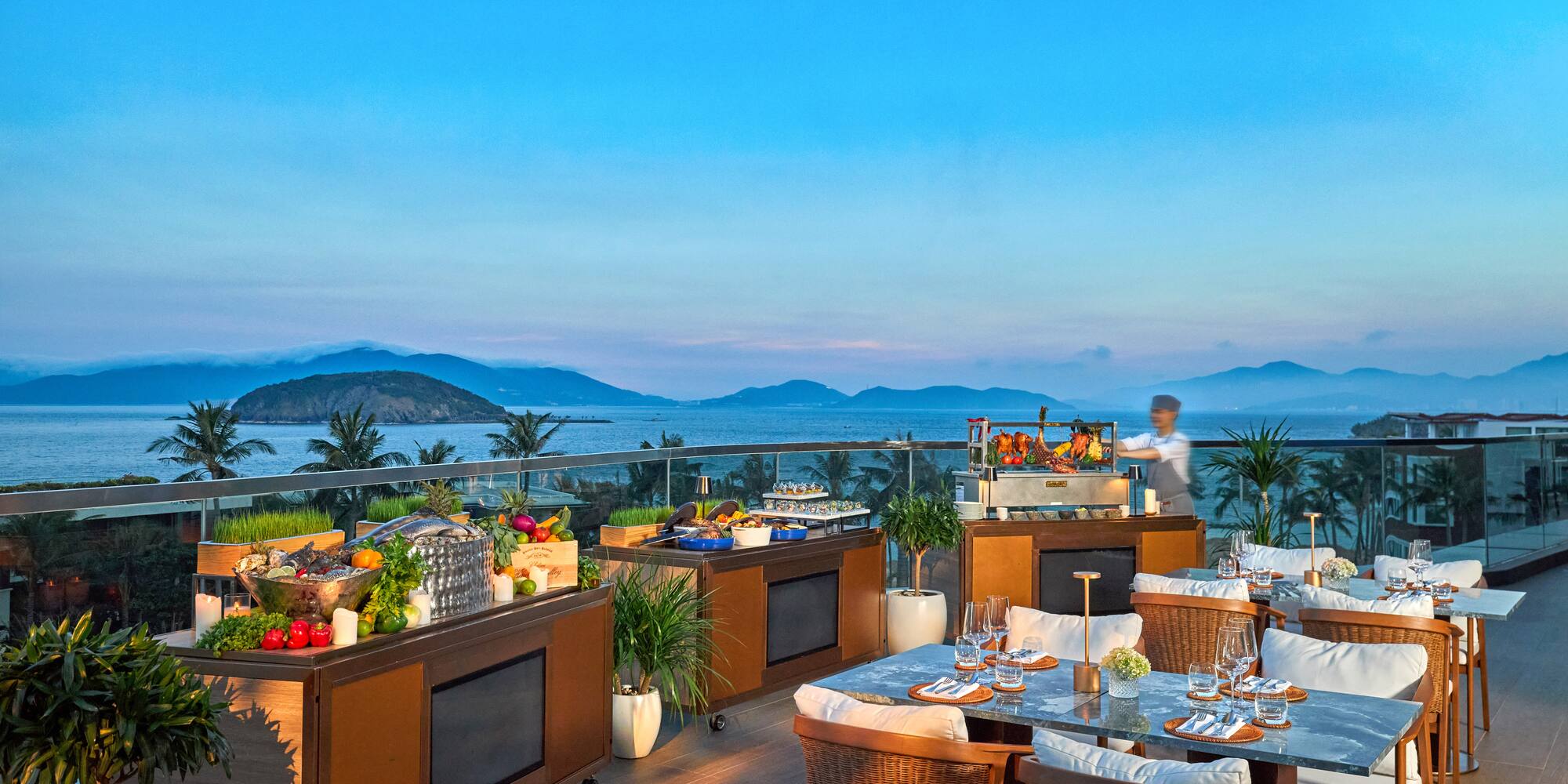 a restaurant with a view of the ocean and mountains