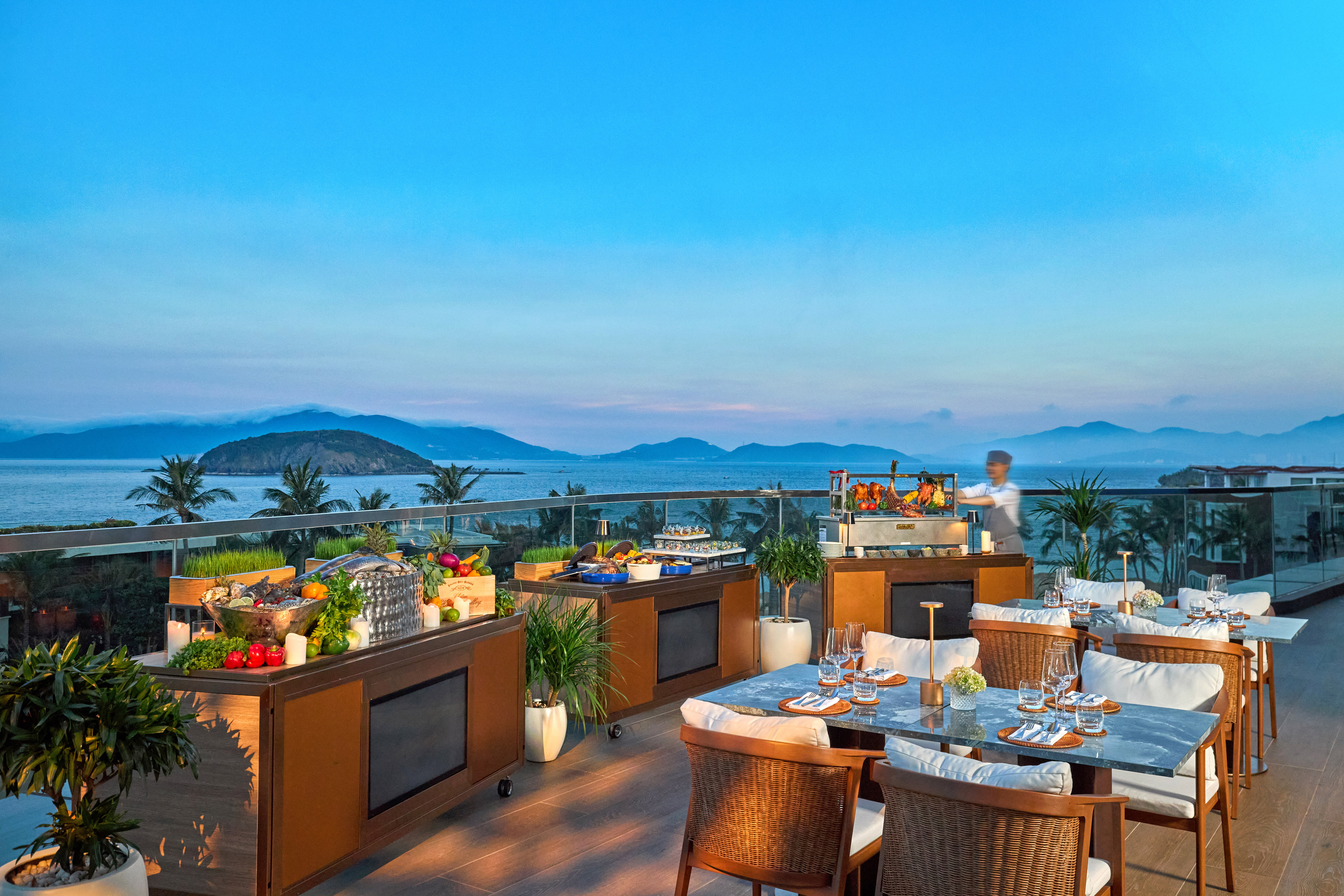 Luxury rooftop resort dining with ocean view, fresh buffet, and chef.