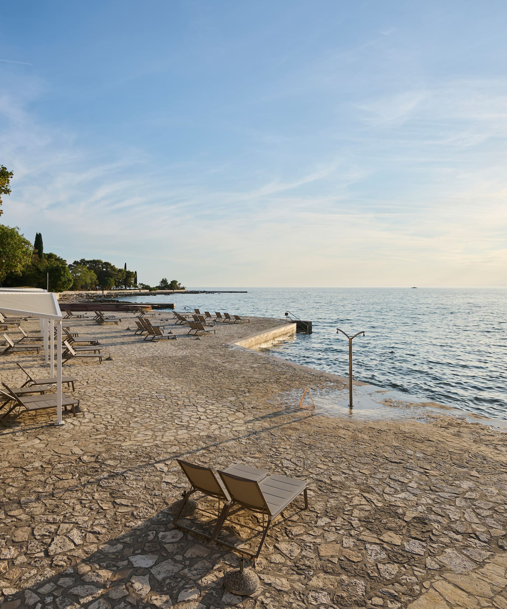 a beach with chairs and umbrellas
