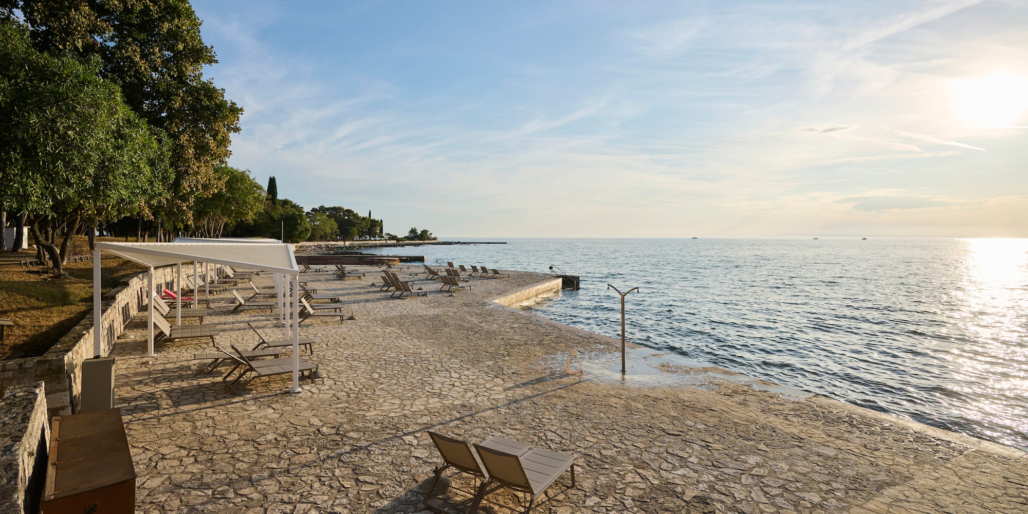 a beach with chairs and umbrellas