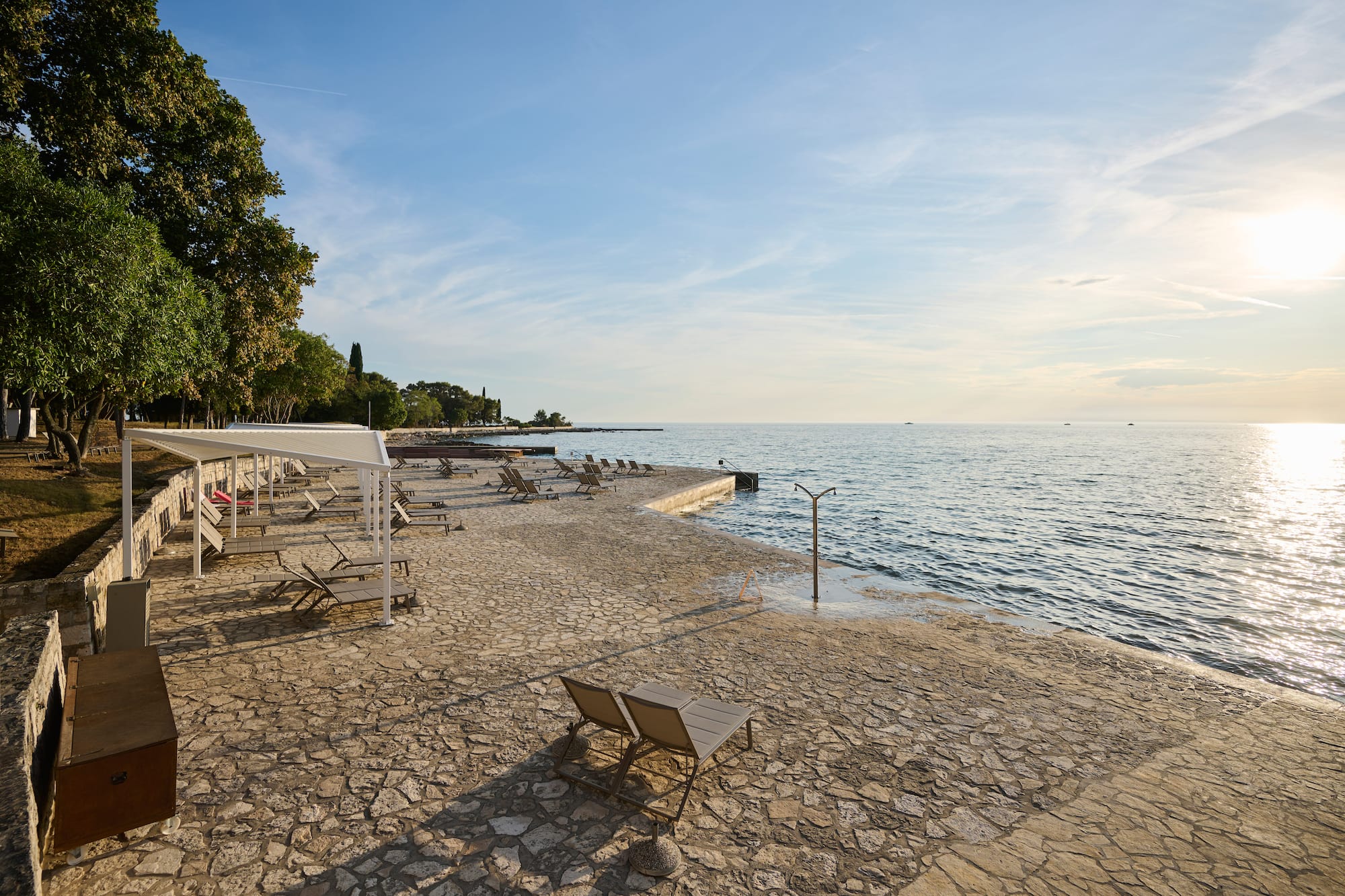 a beach with chairs and umbrellas