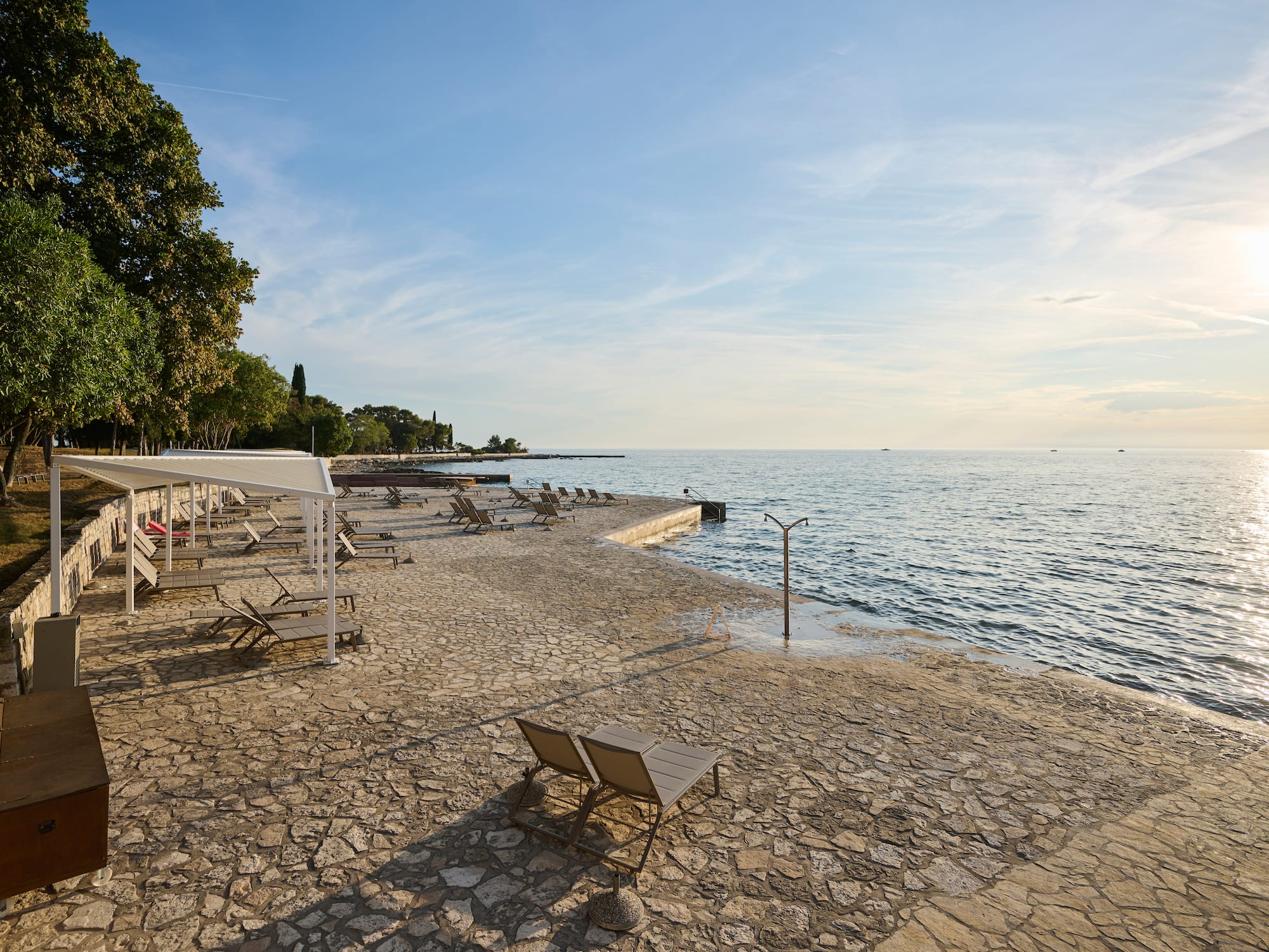 a beach with chairs and umbrellas