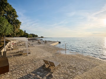 a beach with chairs and umbrellas
