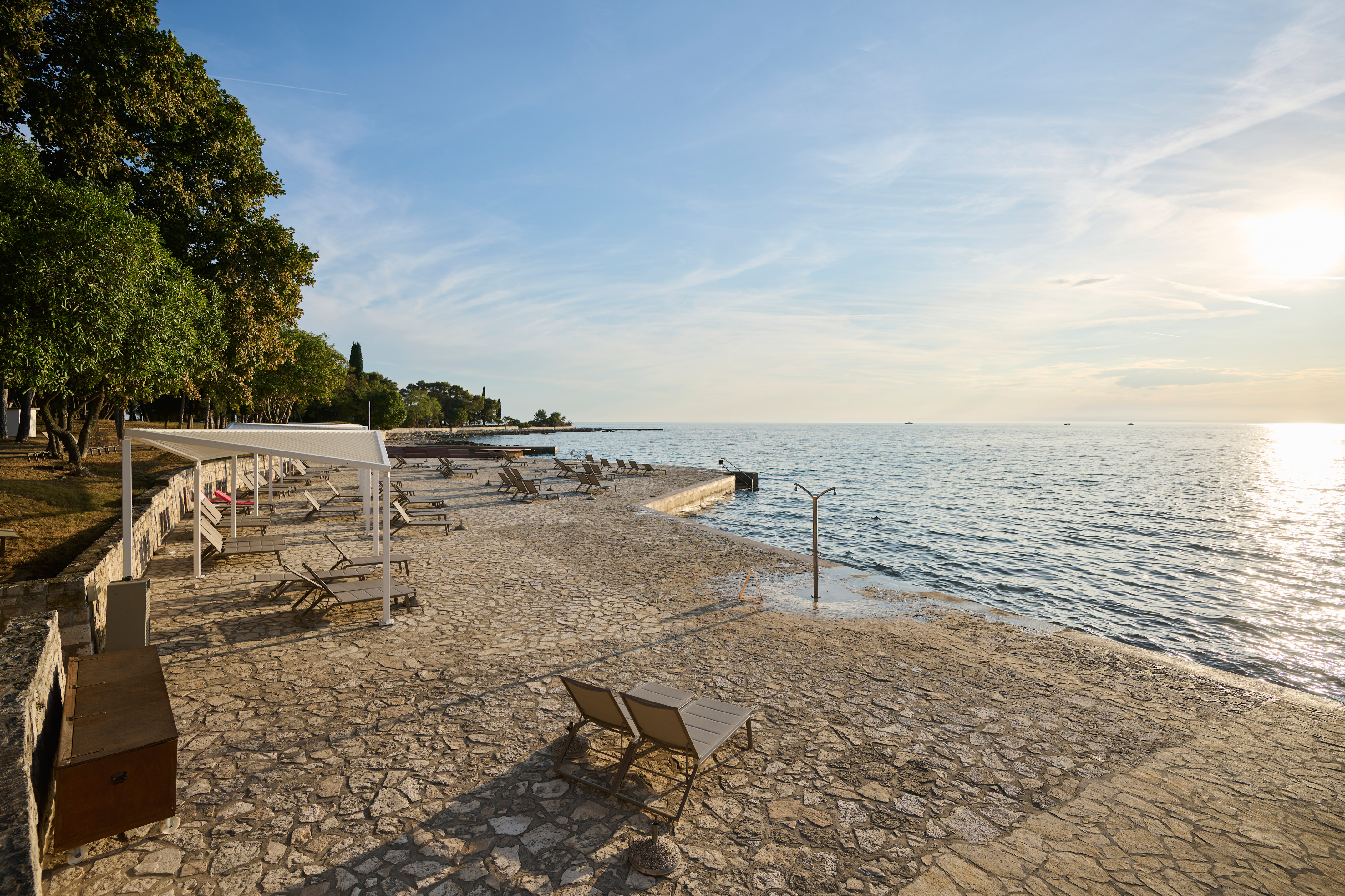 a beach with chairs and umbrellas