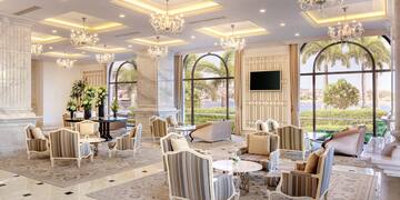 a room with chandeliers and chairs