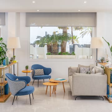 a room with a couch and chairs