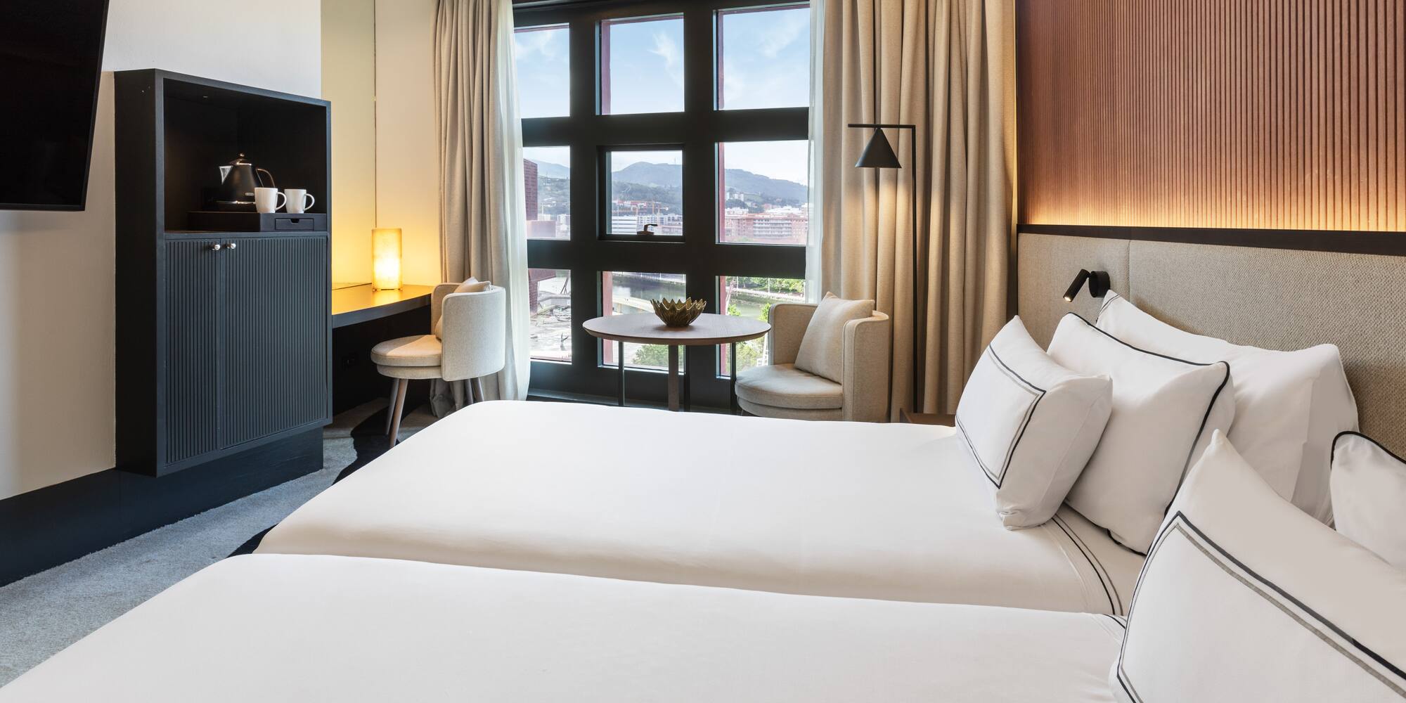 a room with two beds and a table