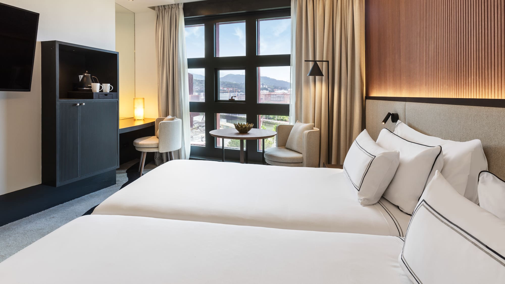 a room with two beds and a table