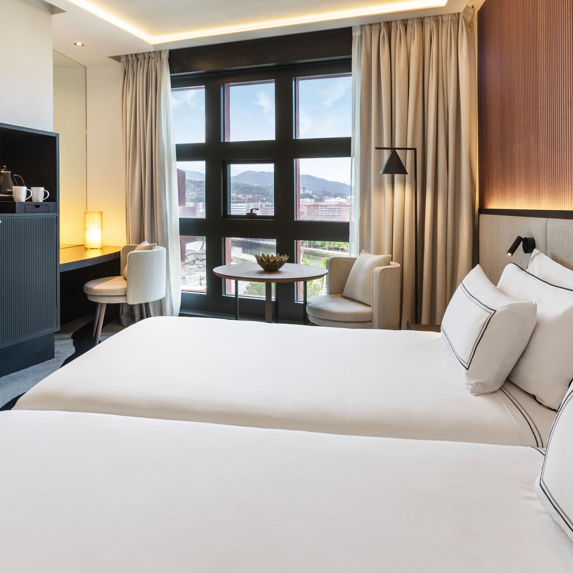 a room with two beds and a table