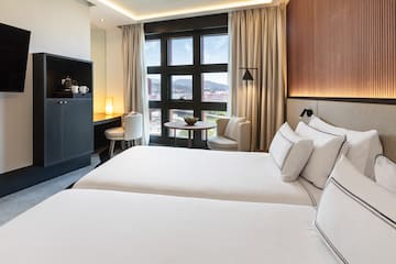 a room with two beds and a table