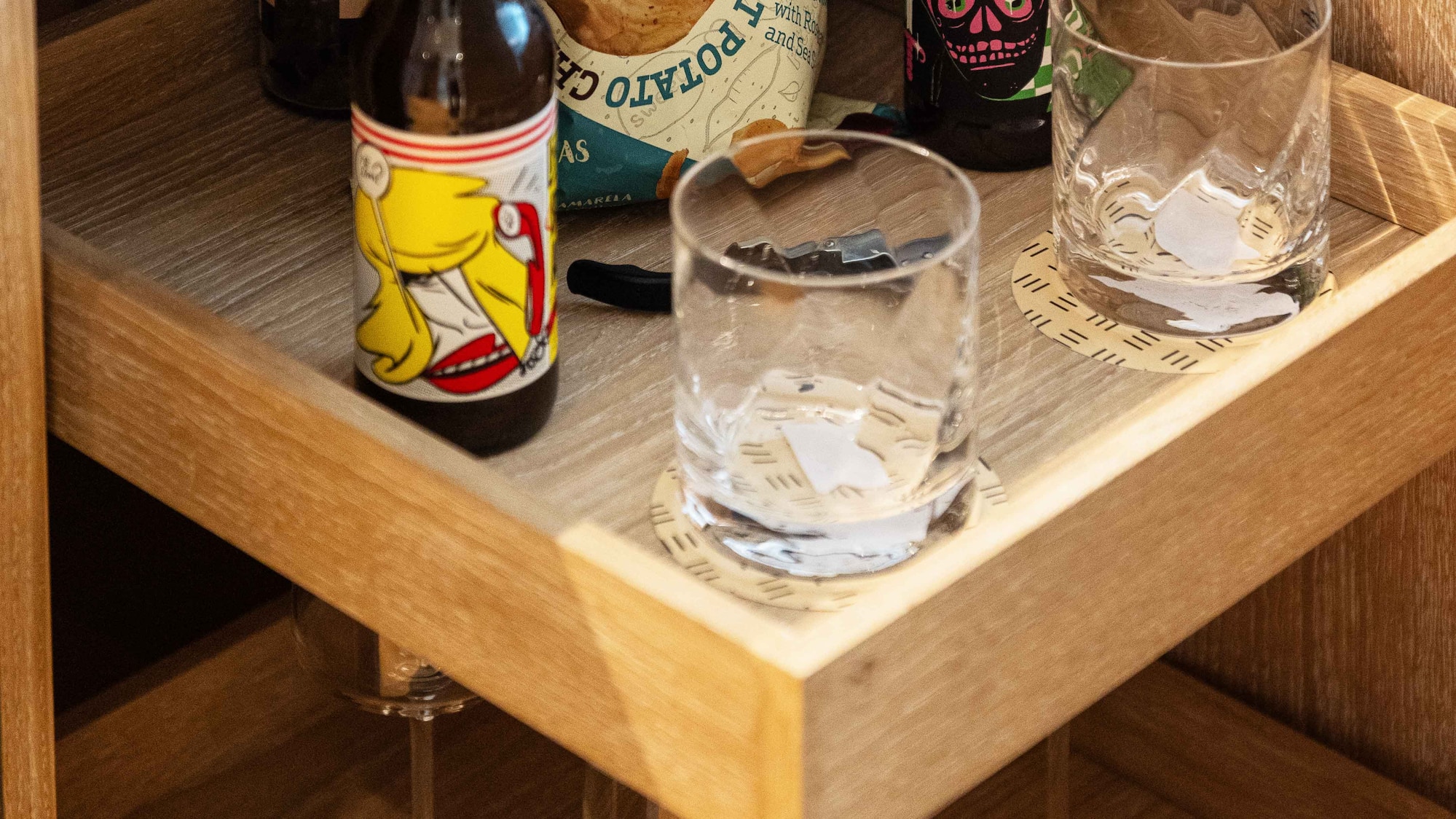 a shelf with bottles and glasses