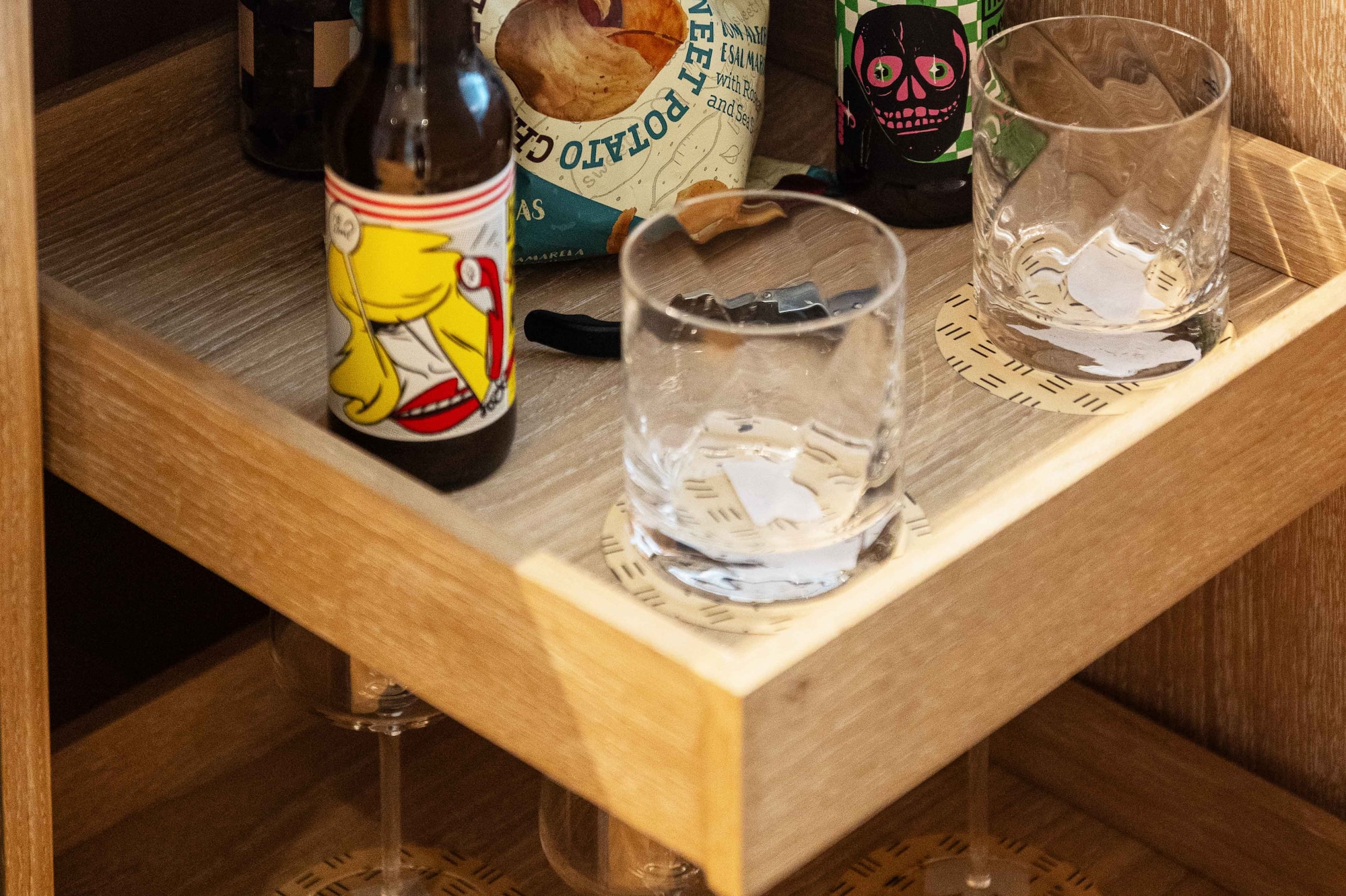 a shelf with bottles and glasses