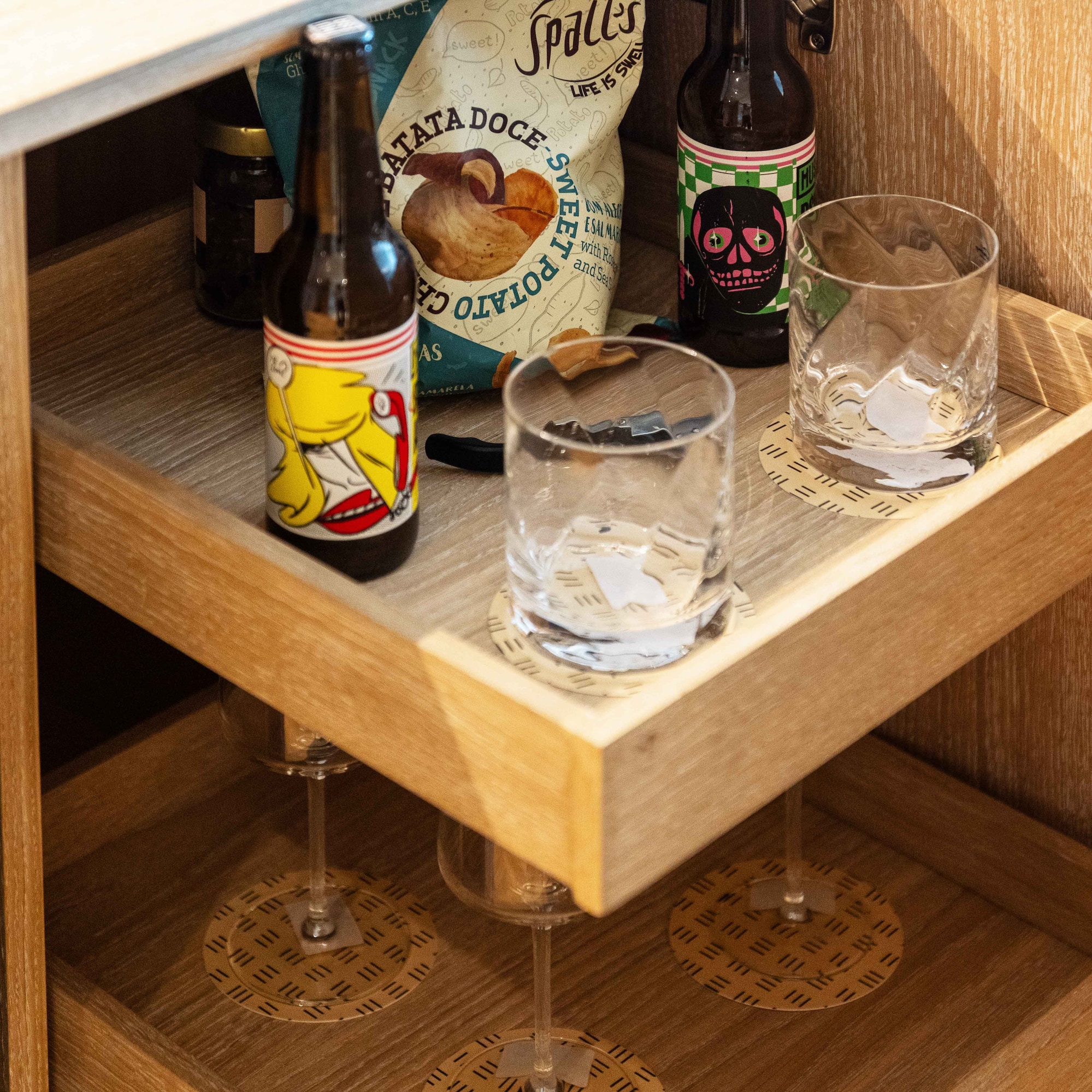 a shelf with bottles and glasses