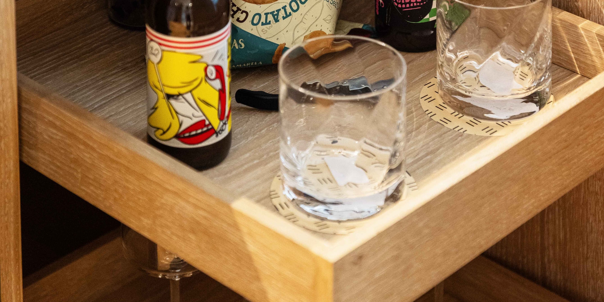 a shelf with bottles and glasses