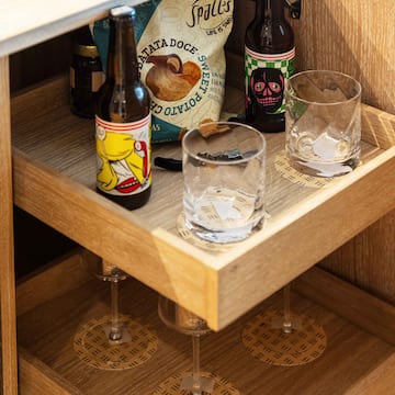 a shelf with bottles and glasses
