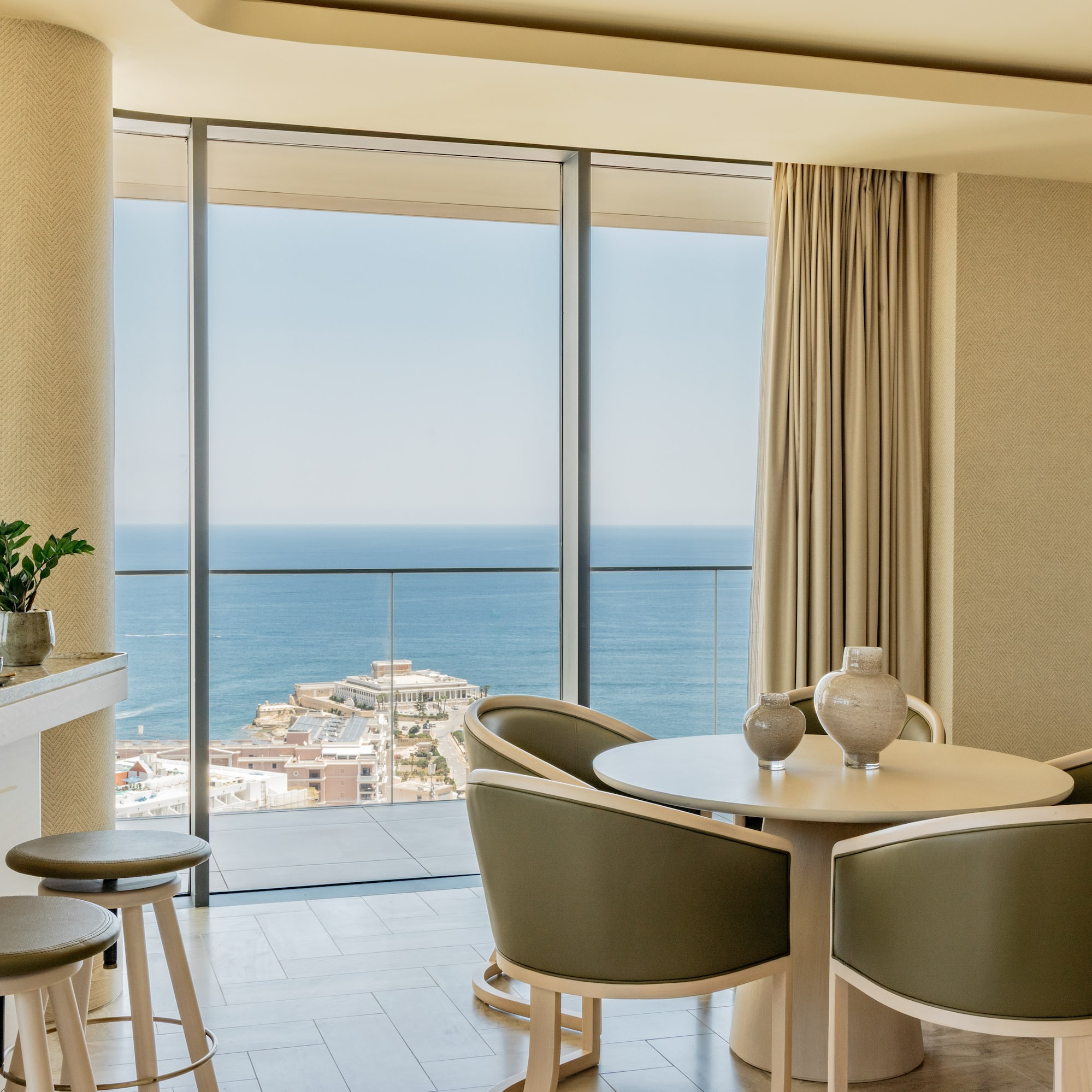 a room with a view of the ocean and a city