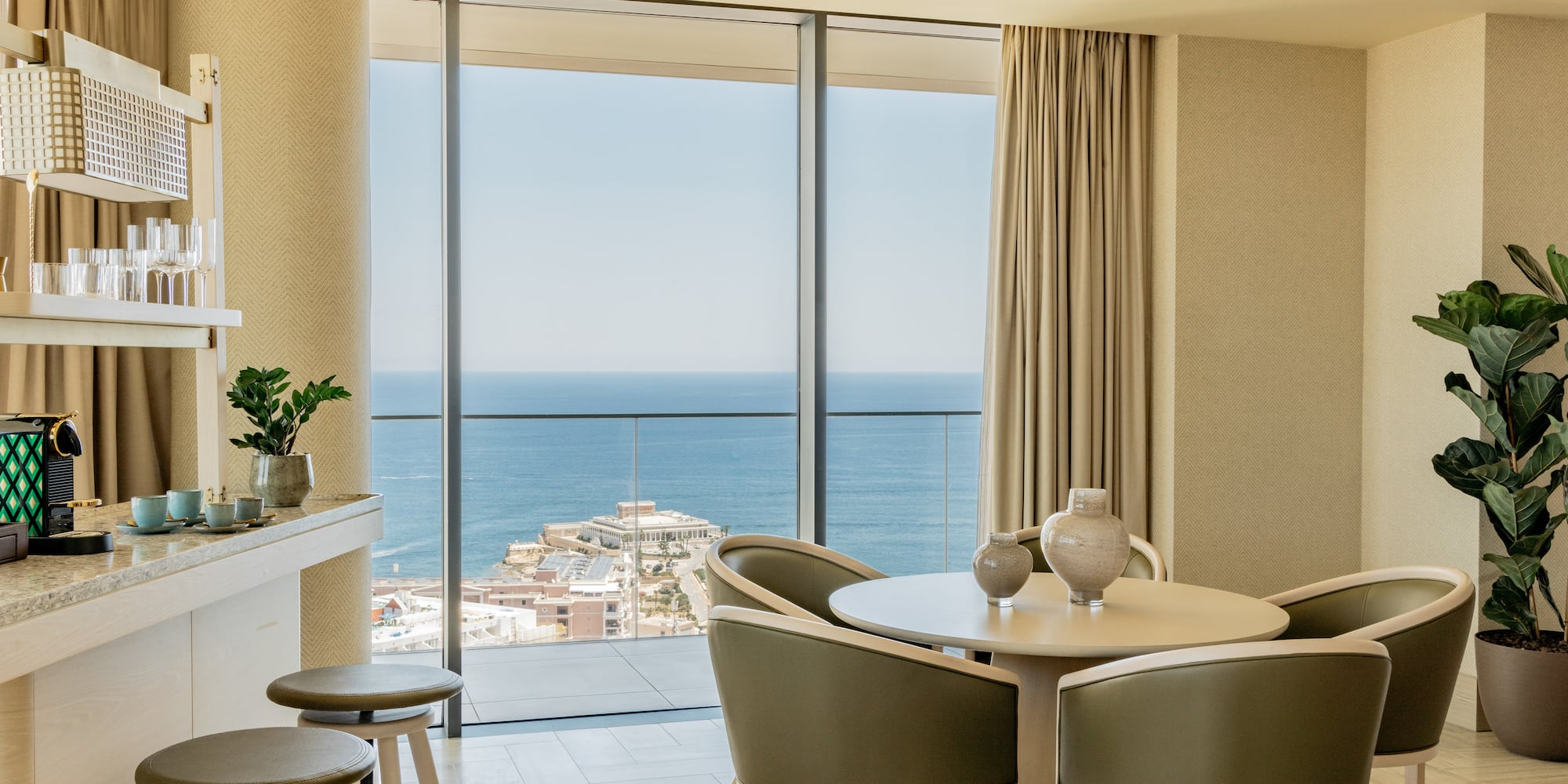 a room with a view of the ocean and a city