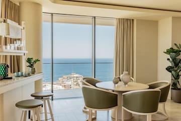 a room with a view of the ocean and a city