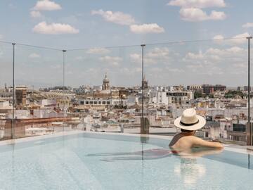 a person in a pool with a city in the background