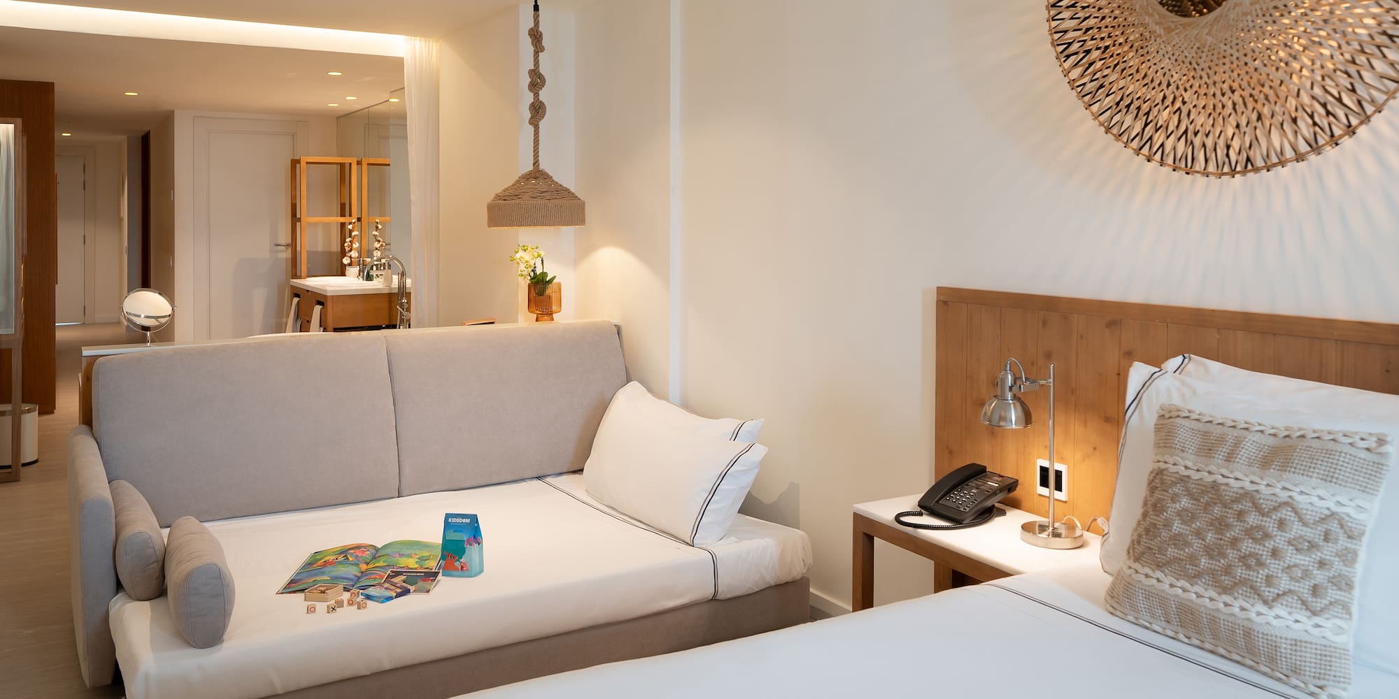 a room with two beds and a mirror