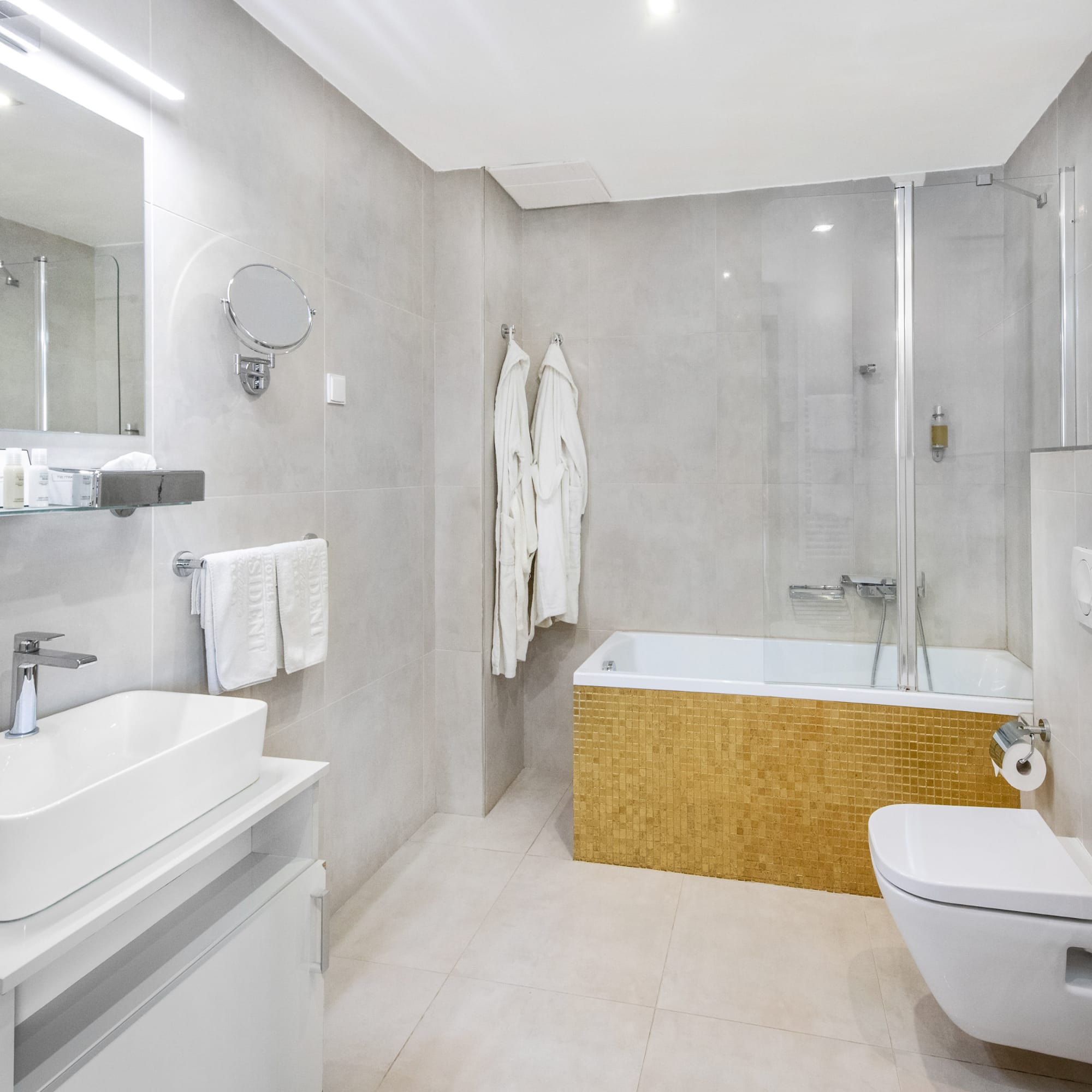 a bathroom with a tub toilet and sink