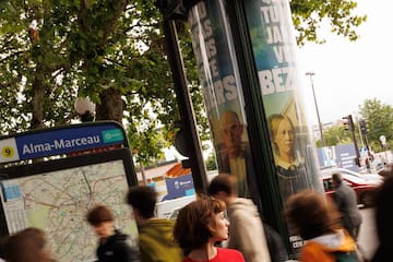 a woman walking on a sidewalk