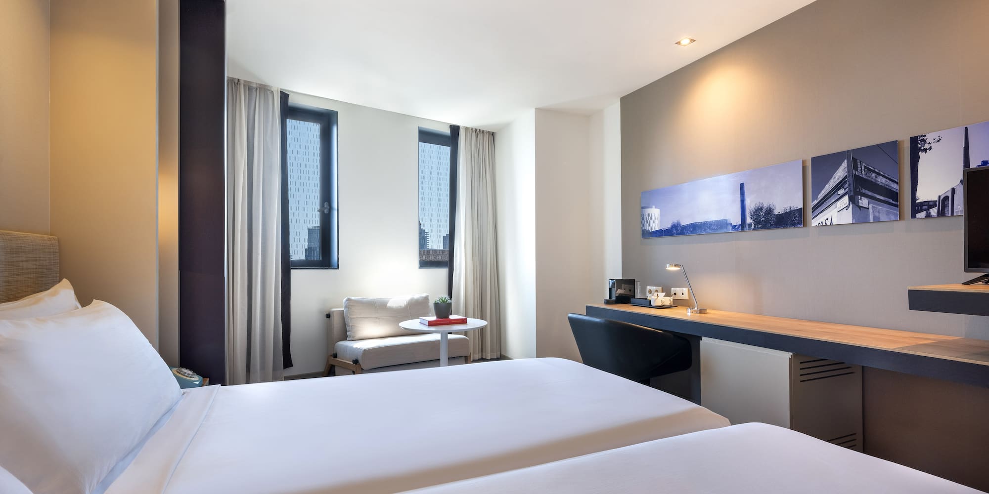 a room with two beds and a desk