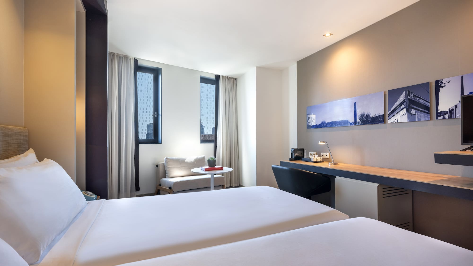 a room with two beds and a desk