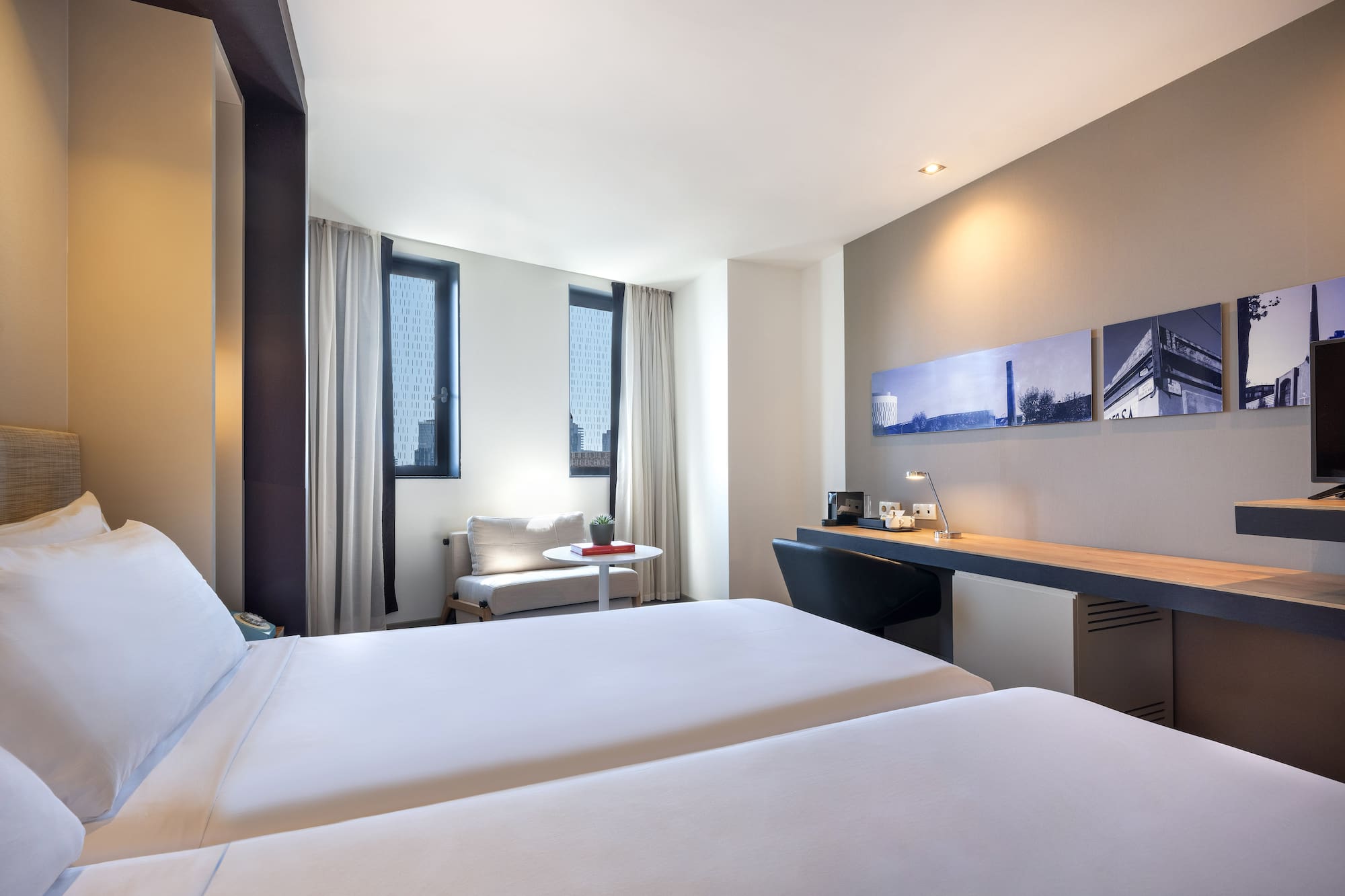 a room with two beds and a desk