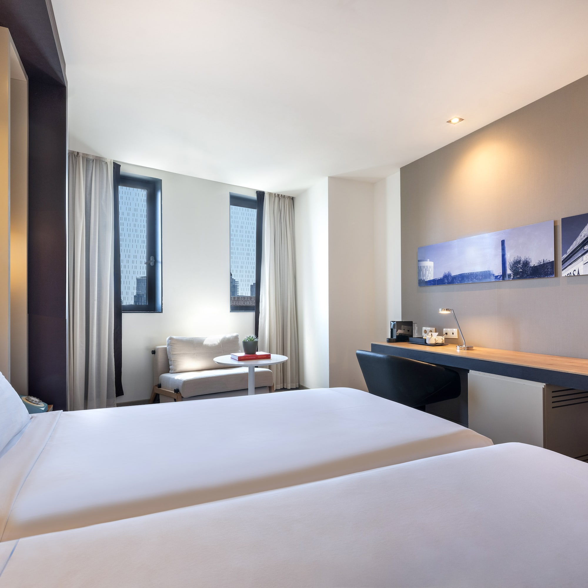 a room with two beds and a desk