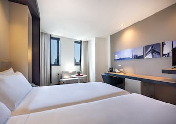 a room with two beds and a desk