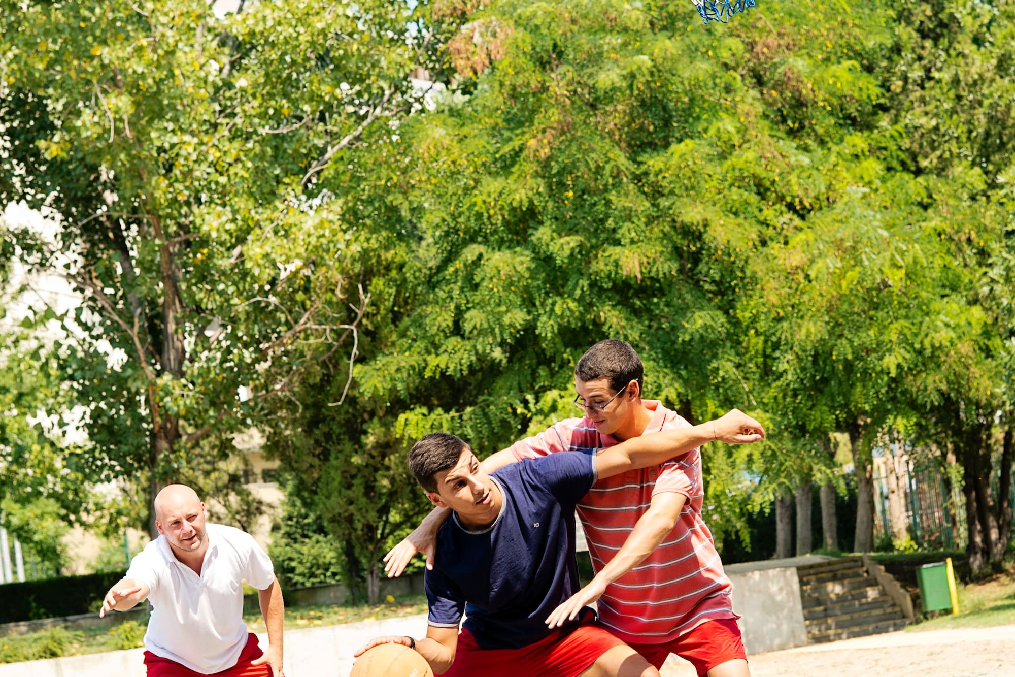 a group of men playing basketball