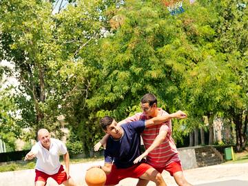 a group of men playing basketball