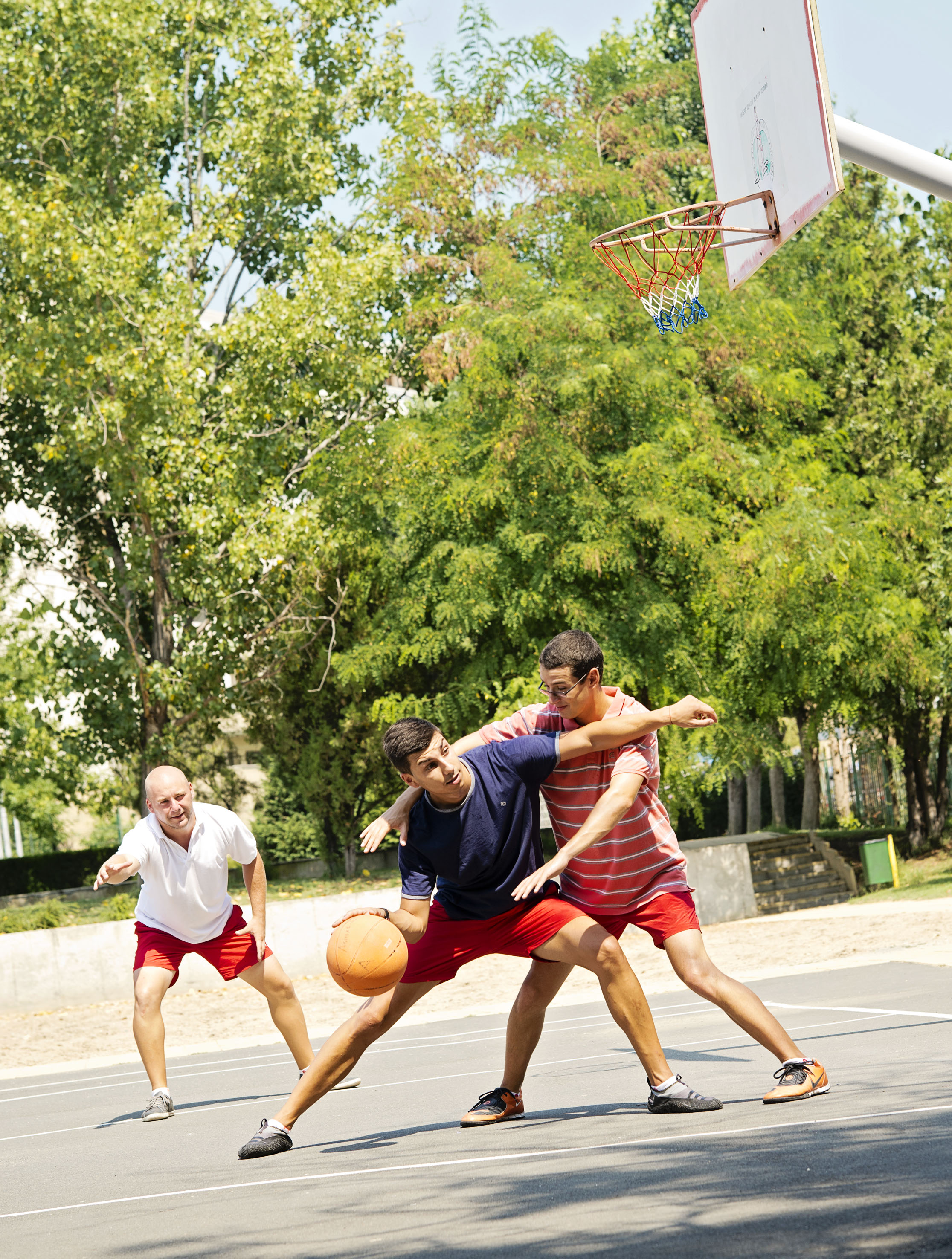 a group of men playing basketball