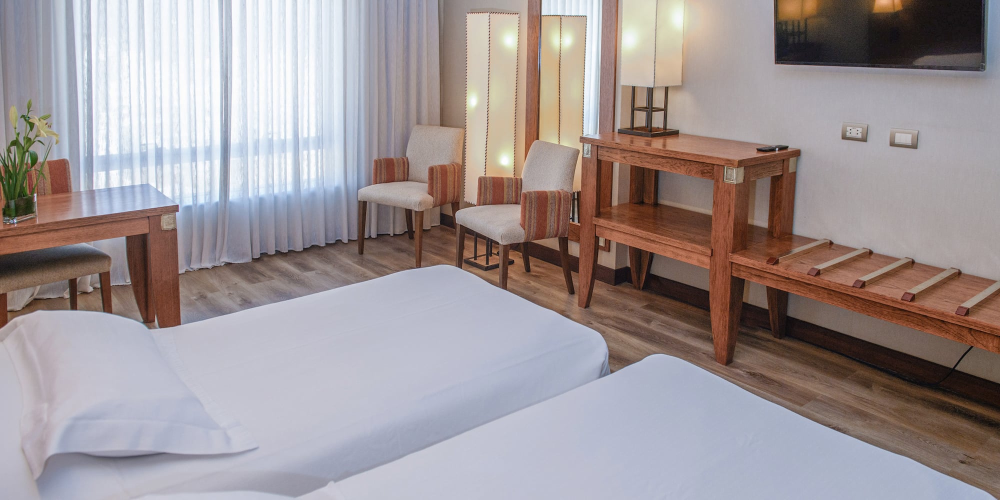 a room with two beds and a mirror