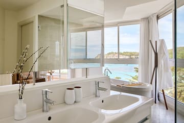 a bathroom with a large window and a sink