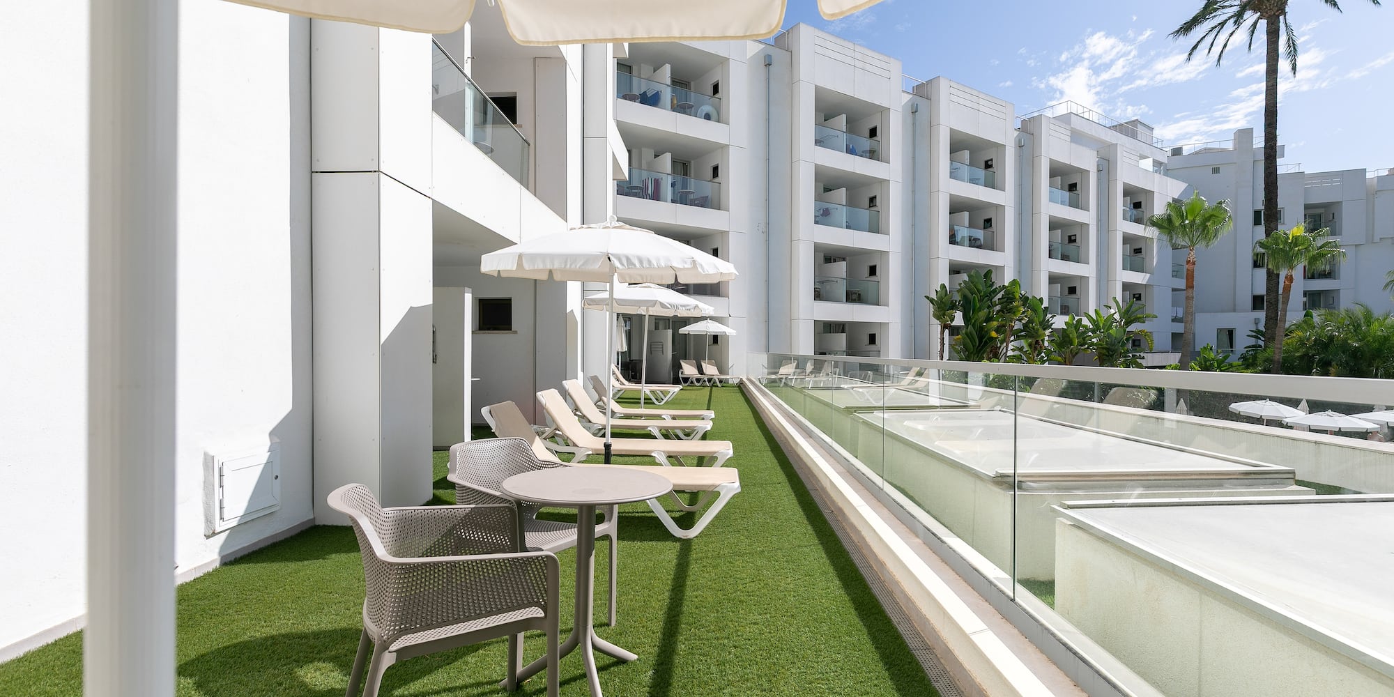 a patio area with chairs and umbrellas