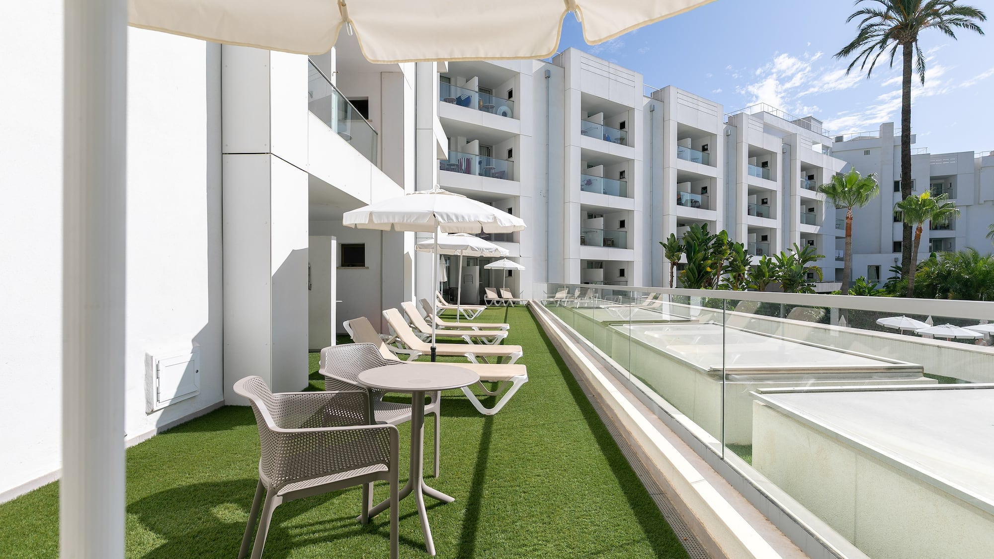 a patio area with chairs and umbrellas