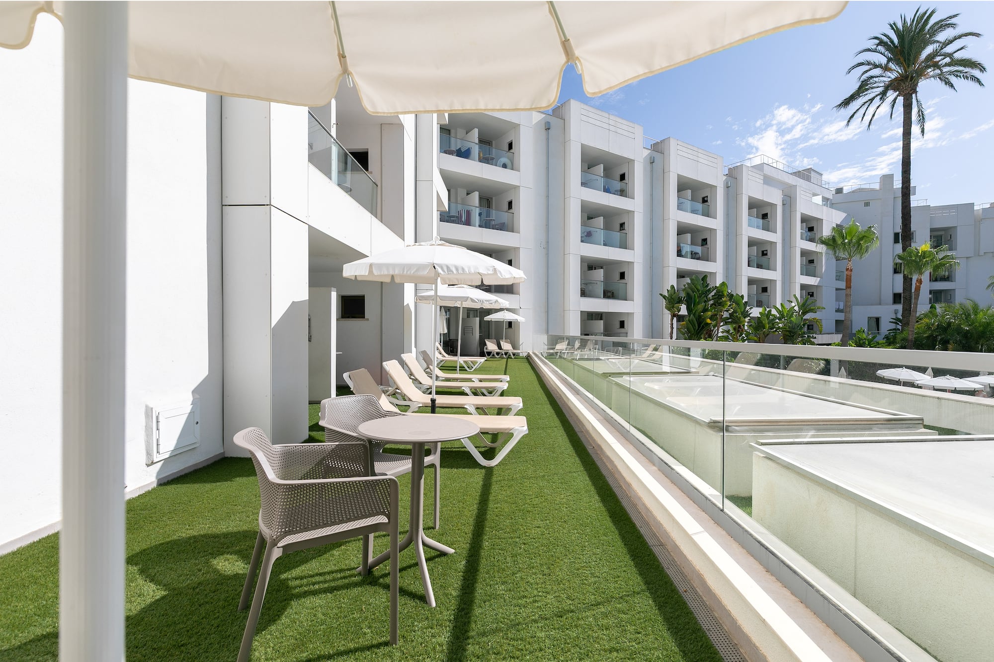 a patio area with chairs and umbrellas