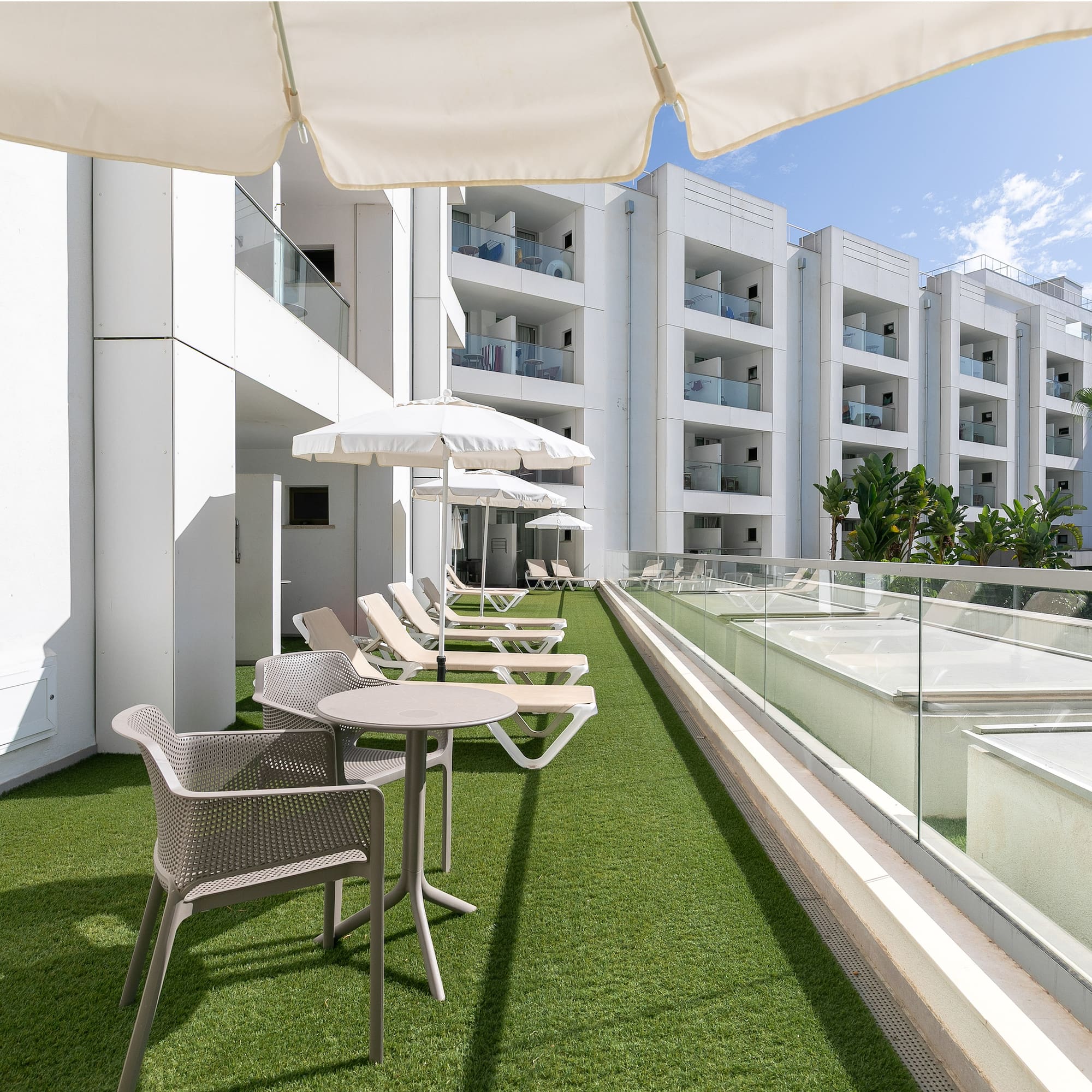 a patio area with chairs and umbrellas
