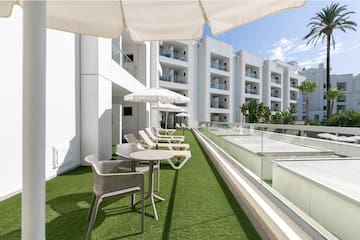 a patio area with chairs and umbrellas