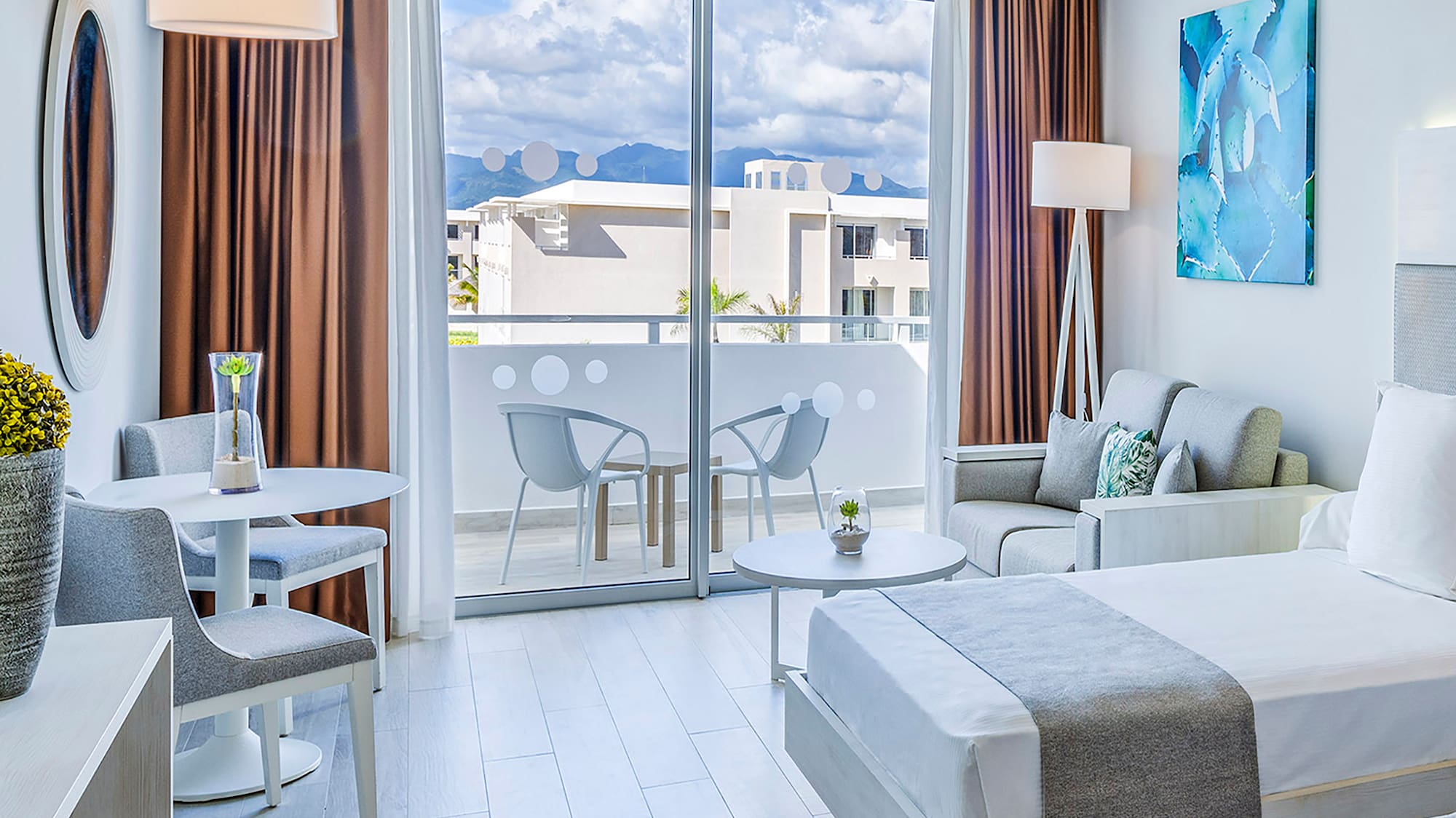 a room with two beds and a table and chairs